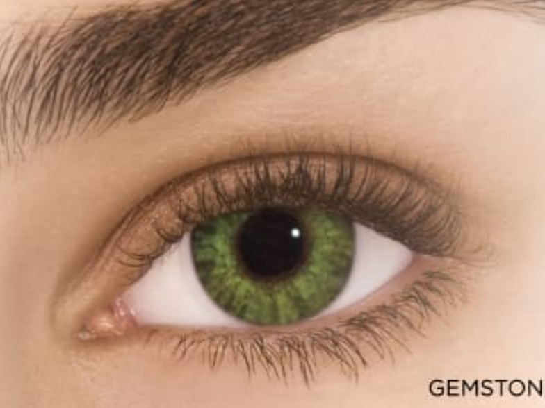 Witch green Halloween contact lens on eye