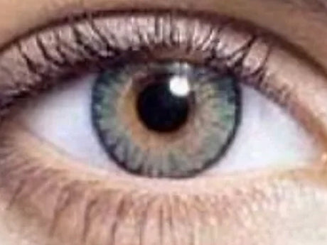 Witch green one-day Halloween contact lens on eye